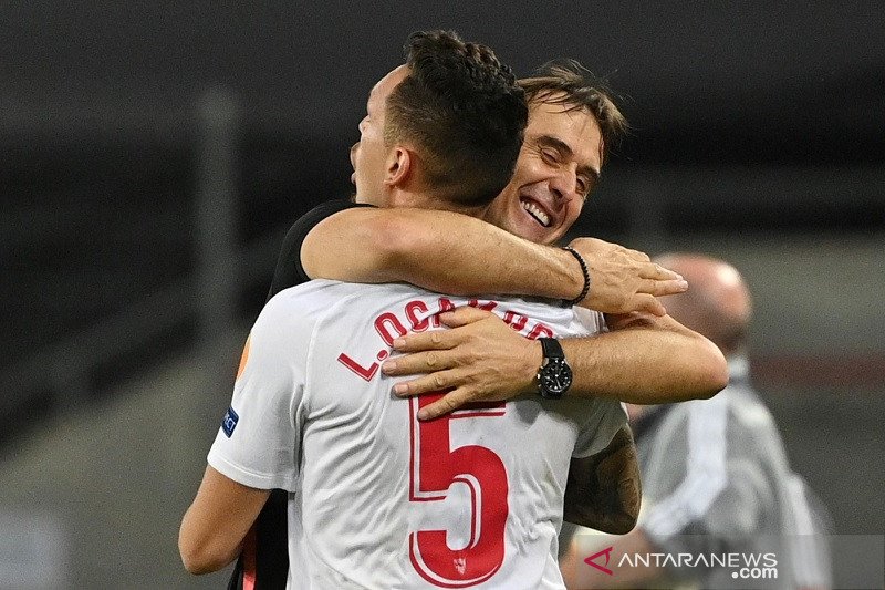 Manajer Sevilla Julen Lopetegui (kanan) memeluk Lucas Ocampos merayakan kemenangan atas Manchester United dalam semifinal Liga Europa di Stadion RheinEnergie, Cologne, Jerman, Minggu (16/8/2020) waktu setempat. (ANTARA/REUTERS/POOL/Ina Fassbender)