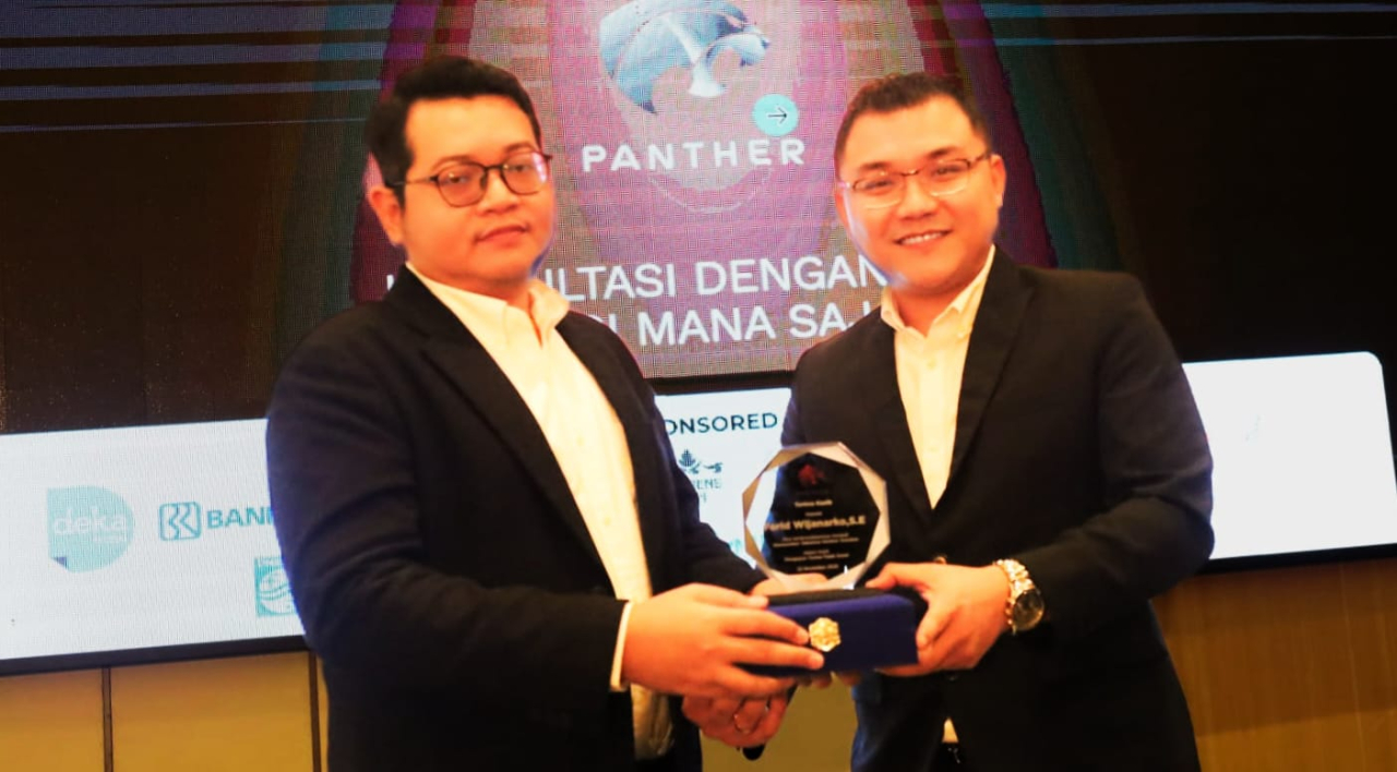 Direktur Panther Solutions, Enrico Changgih(kanan) memberikan cinderamata kepada  Associate Manager Kantor Akuntan Publik Farid Wijanarko usai acara  Panther Solutions di Hotel Deka Surabaya, Sabtu (22/11)
