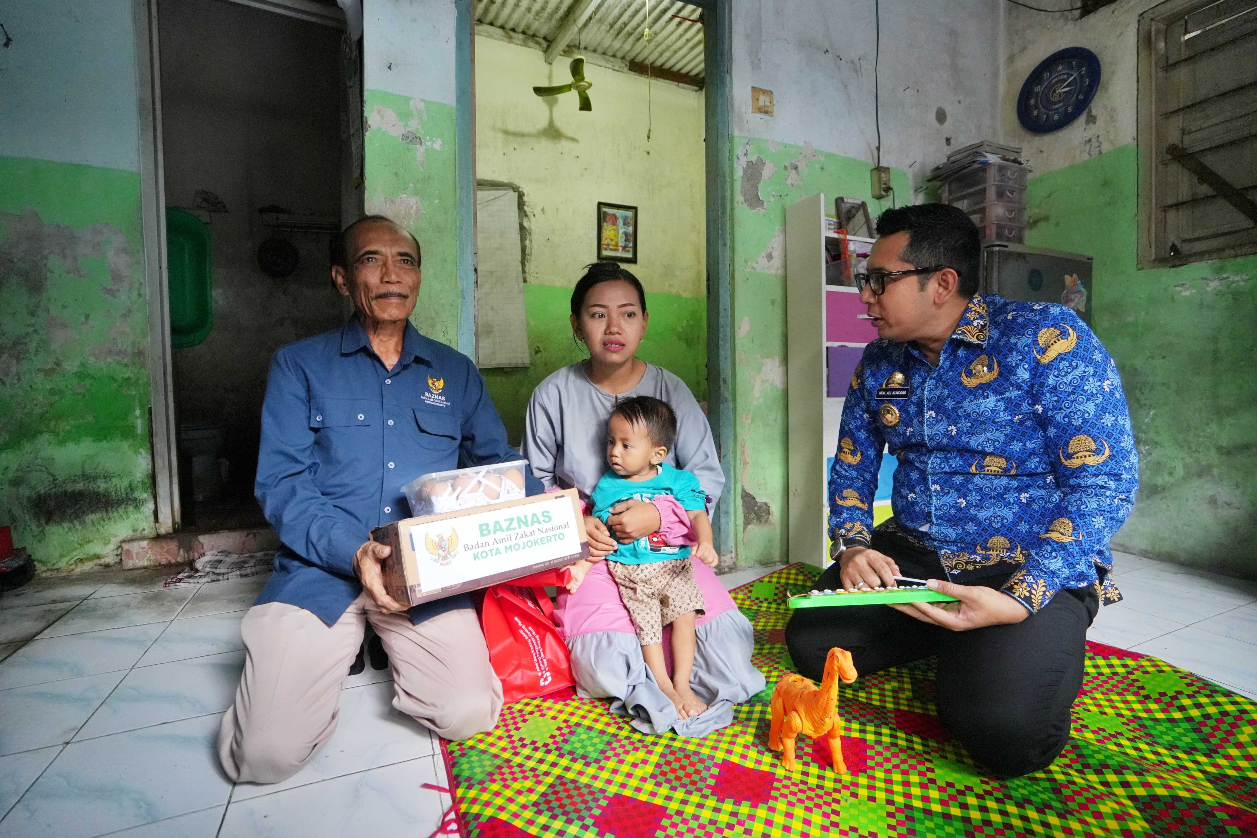 Penjabat (Pj.) Wali Kota Mojokerto M. Ali Kuncoro saat menyrahkan bantuan bersama Baznas Kota Mojokerto