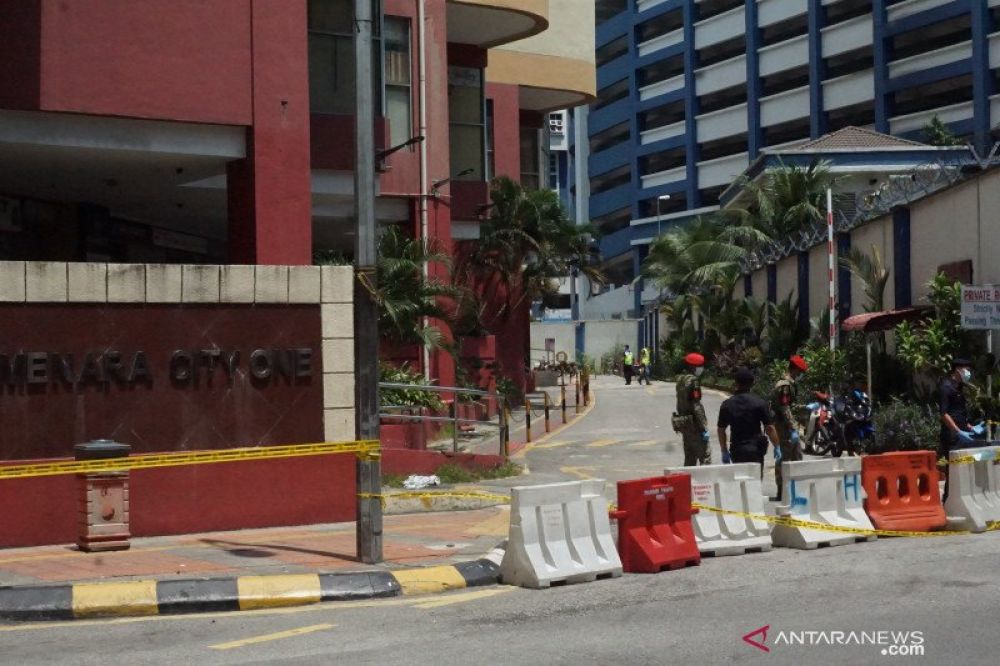 Polisi Diraja Malaysia (PDRM) dan Angkatan Tentara Malaysia (ATM) berjaga-jaga di Apartemen Menara City One Jalan Munshi Abdullah Kuala Lumpur, Selasa (31/3). Penghuni apartemen dan pusat perniagaan tersebut diisolasi atau menjalani Perintah Kawalan Perge