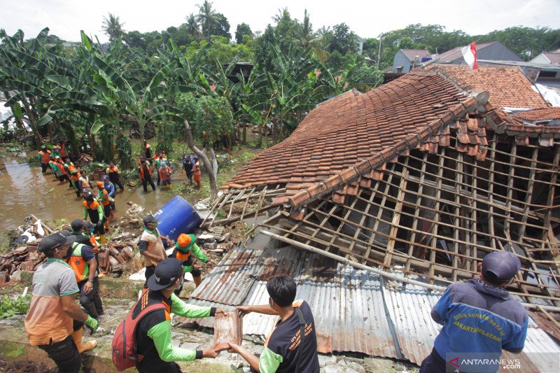 Petugas bersama relawan membenahi rumah warga yang rusak akibat tanah longsor di kawasan Ciganjur, Jakarta, Ahad (11/10/2020). Hujan deras sejak Sabtu (10/10) sore mengakibatkan permukiman penduduk di Jalan Damai RT 004 RW 002, Ciganjur, Jagakarsa, Jakart