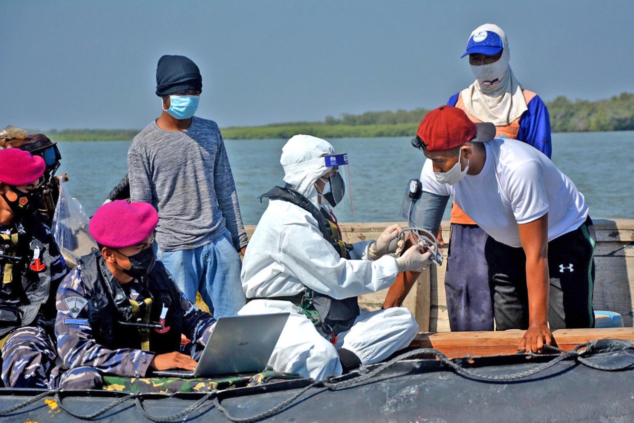 Masyarakat nelayan mendapatkan suntikan vaksin tahap kedua saat mencari ikan di laut, dari Batalyon Infanteri 1 Marinir ketika melaksanakan serbuan vaksin Covid-19 untuk masyarakat maritim di pantai Tambak Cemandi dan Balai Desa Tambak Cemandi Kec. Sedati